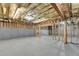 Unfinished basement showing framing and insulation provides a blank slate for customization at 2505 Weber Heights Way, Buford, GA 30519