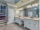 Bathroom featuring double vanity with white cabinets and neutral tile flooring at 2505 Weber Heights Way, Buford, GA 30519