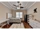 Bright bedroom with hardwood floors, ceiling fan, and white furniture at 2505 Weber Heights Way, Buford, GA 30519