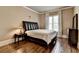 Comfortable bedroom featuring hardwood floors, a plush bed, and a dresser at 2505 Weber Heights Way, Buford, GA 30519