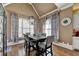 Dining room featuring vaulted ceiling, modern lighting, patterned curtains, and hardwood floors at 2505 Weber Heights Way, Buford, GA 30519