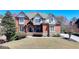 Stately brick and siding home with manicured lawn and mature landscaping at 2505 Weber Heights Way, Buford, GA 30519