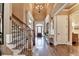 Spacious foyer featuring hardwood floors, stairs with iron spindles, and a chandelier at 2505 Weber Heights Way, Buford, GA 30519