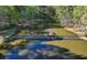 Aerial view of a lake with a gazebo at the end of the walking bridge at 2505 Weber Heights Way, Buford, GA 30519