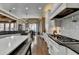 Bright, open kitchen with white cabinets, a gray island, stainless appliances, and hardwood flooring at 2505 Weber Heights Way, Buford, GA 30519