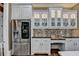 Beautiful kitchen features white cabinets, stainless steel refrigerator, and stylish backsplash at 2505 Weber Heights Way, Buford, GA 30519