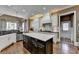 Charming kitchen boasting granite counters, stainless appliances, white cabinets, and a black kitchen island at 2505 Weber Heights Way, Buford, GA 30519