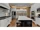 Modern kitchen featuring white cabinets, stainless steel appliances, and spacious island at 2505 Weber Heights Way, Buford, GA 30519