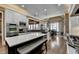 Spacious kitchen featuring white cabinets, stainless appliances, an island with seating, and hardwood floors at 2505 Weber Heights Way, Buford, GA 30519