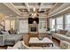 Comfortable living room featuring a fireplace, built-in shelving, coffered ceiling, and plenty of seating at 2505 Weber Heights Way, Buford, GA 30519