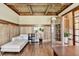 A serene living room showcasing paneled walls, hardwood floors, and a chaise lounge, creating a cozy atmosphere at 2505 Weber Heights Way, Buford, GA 30519