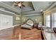 View of a spacious main bedroom featuring hardwood floors and tray ceiling with a ceiling fan at 2505 Weber Heights Way, Buford, GA 30519