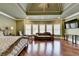An elegant main bedroom featuring hardwood floors, large windows, and a sitting area at 2505 Weber Heights Way, Buford, GA 30519