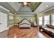 Spacious bedroom with hardwood floors, recessed lighting, and a decorative tray ceiling at 2505 Weber Heights Way, Buford, GA 30519