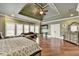 An elegant main bedroom with hardwood floors, large windows, and sitting area at 2505 Weber Heights Way, Buford, GA 30519