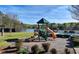 Community playground features slides and climbing area with lake and pool views on a sunny day at 2505 Weber Heights Way, Buford, GA 30519
