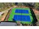 Aerial of tennis courts with a green court surface and black fencing at 2505 Weber Heights Way, Buford, GA 30519