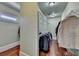 Walk-in closet with built-in shelving and hardwood floors at 2505 Weber Heights Way, Buford, GA 30519