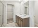 Bright bathroom featuring dual sinks with modern fixtures and a glass-enclosed shower, offering a spa-like experience at 2770 Aralynn Way, College Park, GA 30337