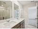 Bright bathroom with dual sinks, a large mirror, and a glass-enclosed shower, offering a luxurious and functional space at 2770 Aralynn Way, College Park, GA 30337