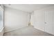 A carpeted bedroom featuring a window with blinds and a closet at 2770 Aralynn Way, College Park, GA 30337