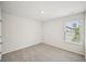 A carpeted bedroom featuring a window with blinds and natural light at 2770 Aralynn Way, College Park, GA 30337