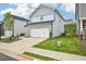 Attractive two-story home features an attached garage and verdant lawn at 2770 Aralynn Way, College Park, GA 30337