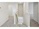 Upstairs hallway featuring neutral paint, carpet, and access to multiple rooms at 2770 Aralynn Way, College Park, GA 30337