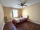 Bedroom with hardwood floors, neutral walls, and a ceiling fan at 315 Seasons Pkwy, Norcross, GA 30093