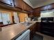 Cozy kitchen featuring wood cabinetry and a pass-through to an adjacent room at 315 Seasons Pkwy, Norcross, GA 30093