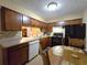 Traditional eat-in kitchen with wood cabinets, tiled backsplash, and black appliances at 315 Seasons Pkwy, Norcross, GA 30093