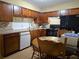 Functional kitchen with dark wood cabinets, stainless steel appliances and ceramic tile floor at 315 Seasons Pkwy, Norcross, GA 30093
