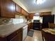 Functional kitchen with dark wood cabinets, stainless steel appliances and ceramic tile floor at 315 Seasons Pkwy, Norcross, GA 30093