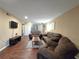 Spacious living room boasts hardwood floors, recessed lighting, neutral paint, and a comfortable seating area at 315 Seasons Pkwy, Norcross, GA 30093