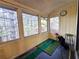 A sunroom overlooking a lush, green, tree filled landscape with a golf practice area at 315 Seasons Pkwy, Norcross, GA 30093