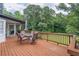 View of the back deck with a patio table and chairs, overlooking a lush yard at 3442 Inns Brook Way, Snellville, GA 30039