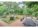 Outdoor wooden deck overlooking backyard and green space, with patio furniture and grill at 3442 Inns Brook Way, Snellville, GA 30039