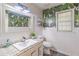 Stylish bathroom with tropical wallpaper, a modern vanity, and a bright window for natural light at 3442 Inns Brook Way, Snellville, GA 30039