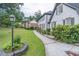 Well-maintained home exterior with lush green lawn and landscaped walkway at 3442 Inns Brook Way, Snellville, GA 30039