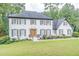 Charming two-story brick home featuring a well-manicured lawn and lush landscaping at 3442 Inns Brook Way, Snellville, GA 30039
