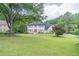 Two-story brick home with a spacious front yard and mature trees at 3442 Inns Brook Way, Snellville, GA 30039