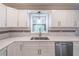 Bright kitchen with white cabinets, subway tile backsplash, and a stainless steel dishwasher at 3442 Inns Brook Way, Snellville, GA 30039