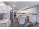 Well-lit kitchen showcasing white cabinets, stainless steel appliances, and a functional island for cooking at 3442 Inns Brook Way, Snellville, GA 30039