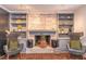 Charming living area featuring a brick fireplace, built-in shelves, and hardwood floors for a cozy atmosphere at 3442 Inns Brook Way, Snellville, GA 30039