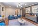 Stylish living room with modern lighting, a blue velvet sofa, and sophisticated decor at 3442 Inns Brook Way, Snellville, GA 30039