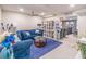 Cozy living room featuring a blue sofa, a bookshelf, and elegant decor at 3442 Inns Brook Way, Snellville, GA 30039