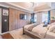 The main bedroom has a tray ceiling, wood paneling, seating area and large windows at 3442 Inns Brook Way, Snellville, GA 30039