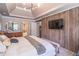 A spacious main bedroom with wood paneling and a large television at 3442 Inns Brook Way, Snellville, GA 30039