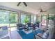 Bright sunroom with large windows, ceiling fans, seating, and natural light at 3442 Inns Brook Way, Snellville, GA 30039