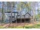 Back exterior with tiered deck overlooking backyard at 477 Victoria Rd, Woodstock, GA 30189